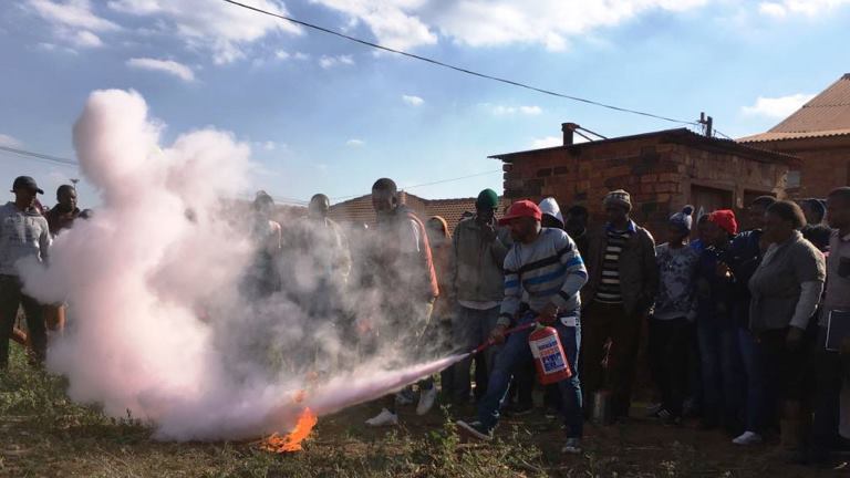 Home Based Fire Safety participant demonstration of fire extinction
